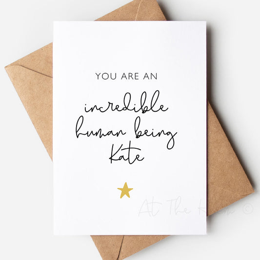 White card with black text that reads "You are an incredible human being Kate" and a yellow star - Personalised Greeting Cards from At The Helm NZ