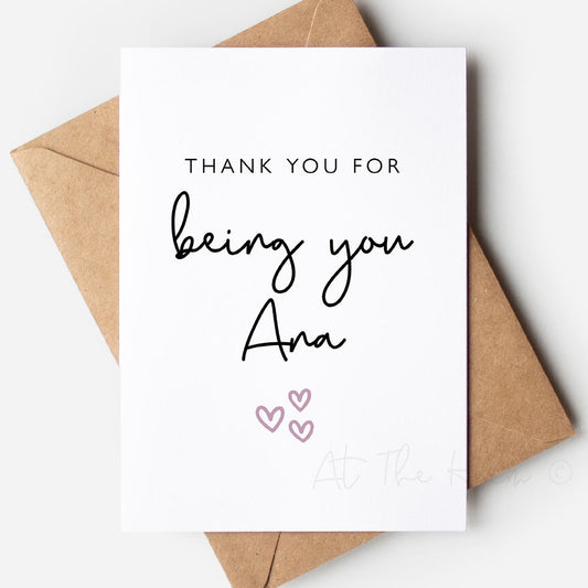 White greeting card with black text and a pink heart. Card reads "thank you for being you Ana" - Personalised greeting cards from At The Helm NZ