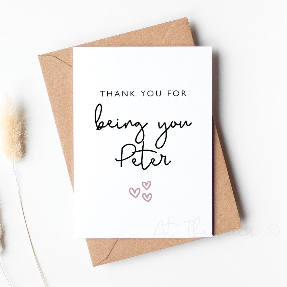 White greeting card with black text and a pink heart. Card reads "thank you for being you Peter" - Personalised greeting cards from At The Helm NZ