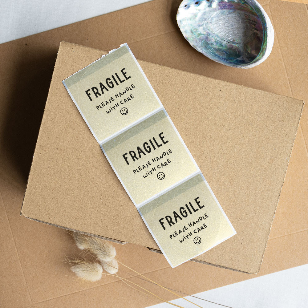 Fragile handle with care packaging sticker gold - At The Helm NZ