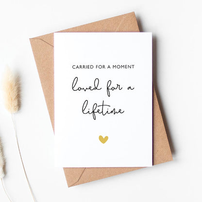 White card with black text that reads "carried for a moment, loved for a lifetime" - miscarriage support card - At The Helm 